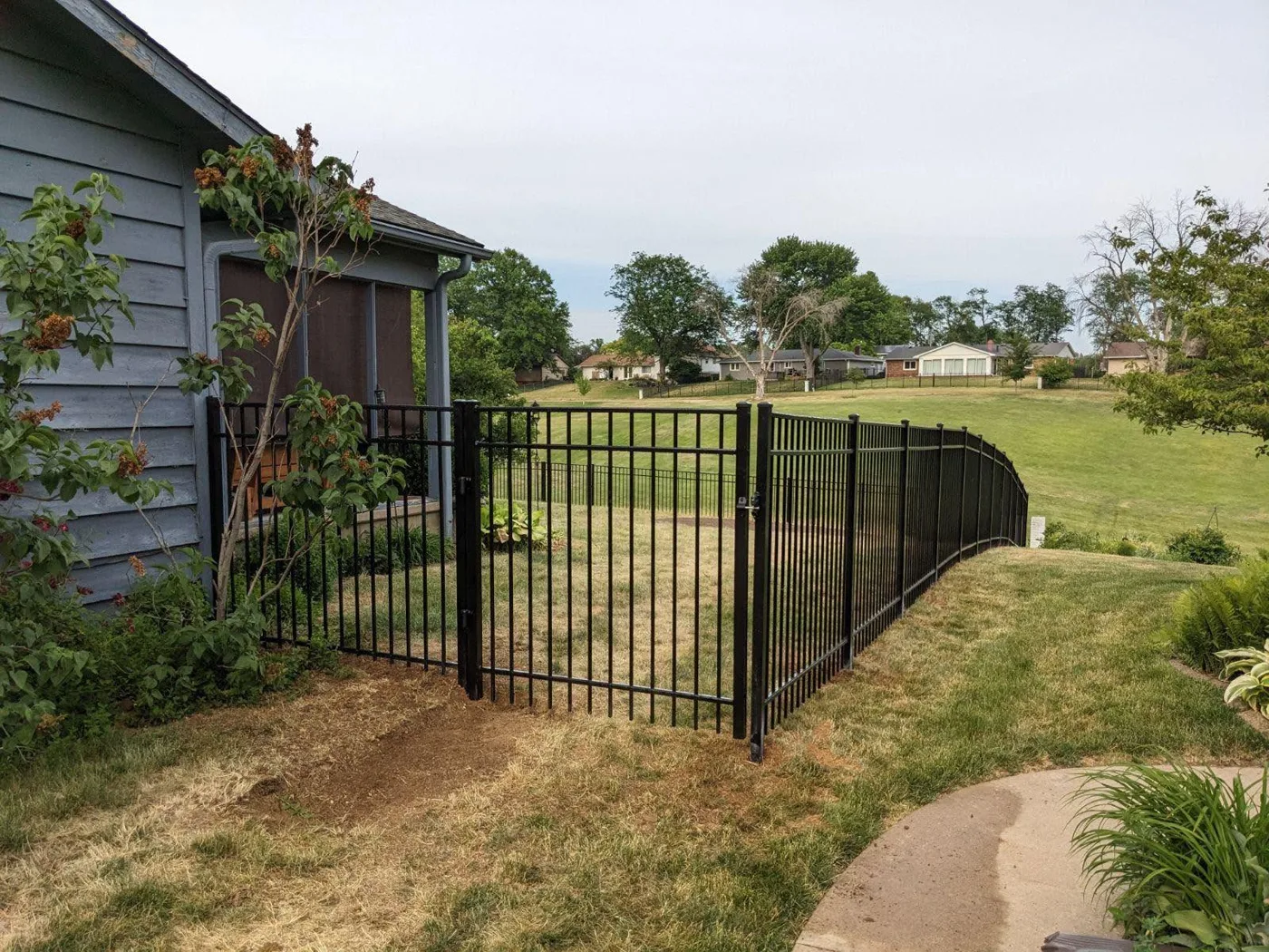 Black aluminum fence enclosing a residential backyard in Central Illinois