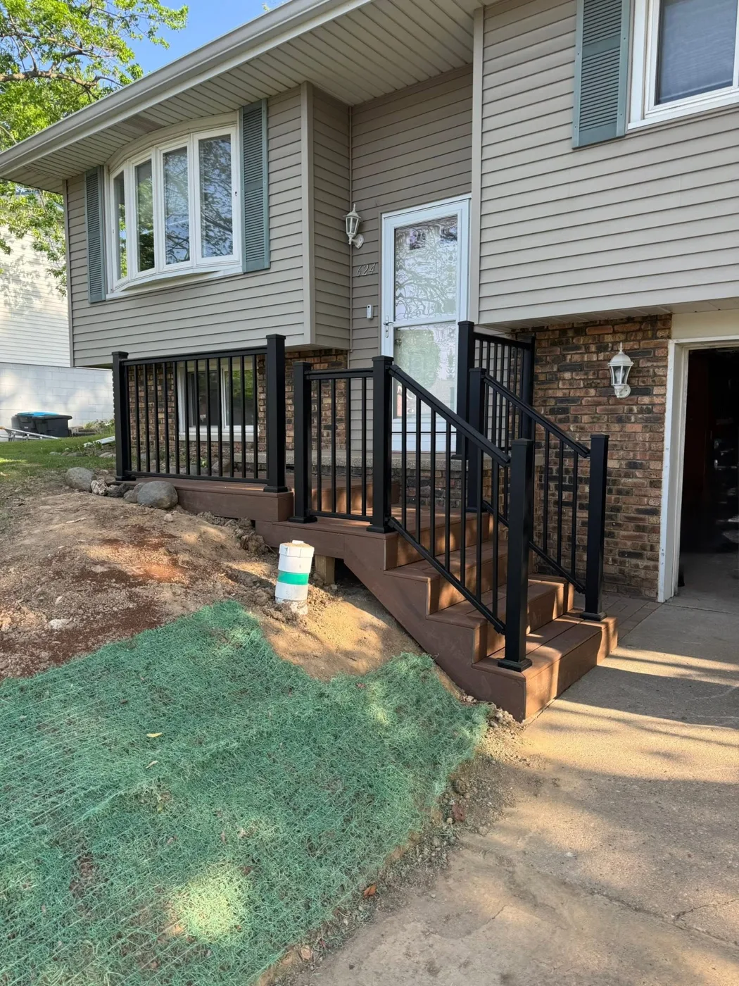 Black aluminum railing installed on front entry steps in Pekin, Illinois