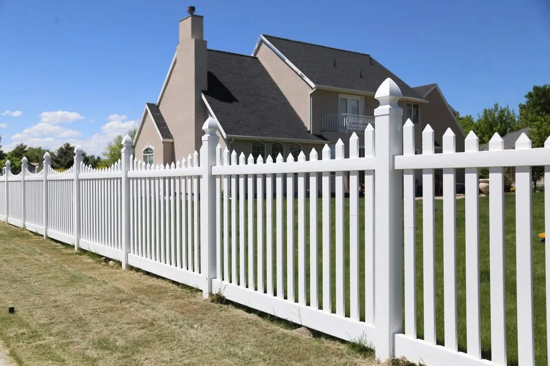 White vinyl picket fence around a front yard in Central Illinois
